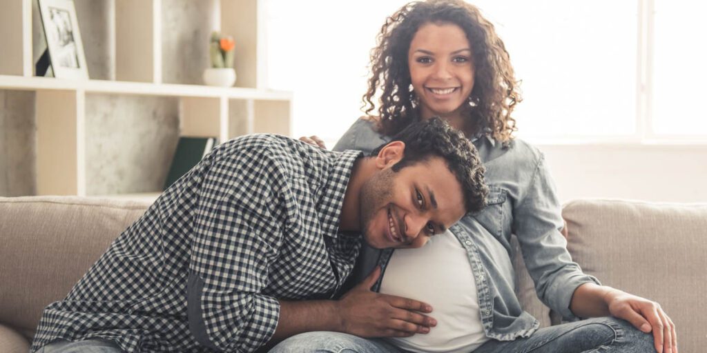 she is pregnant, he is laying her head on her stomach
